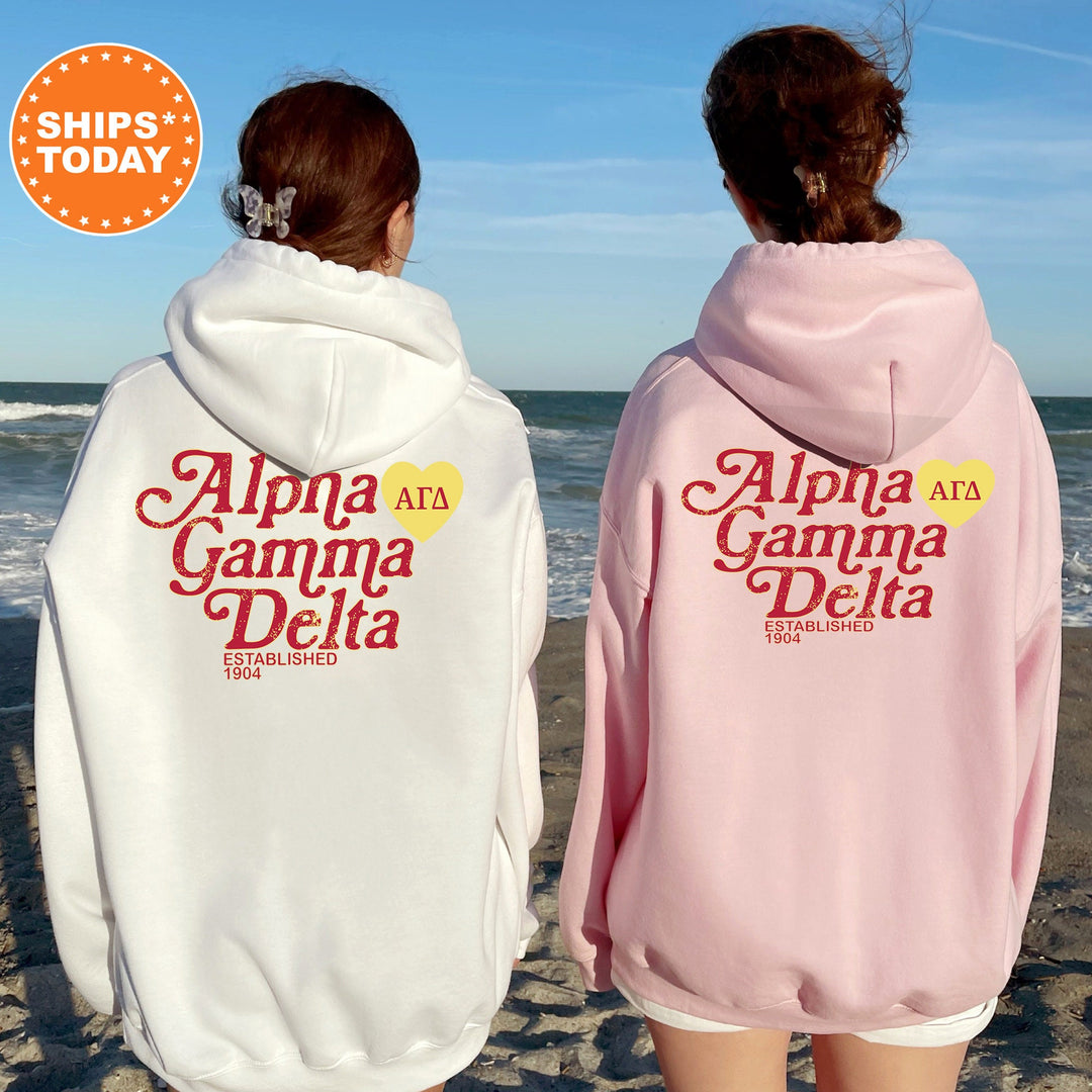 two girls wearing pink and white hoodies on the beach