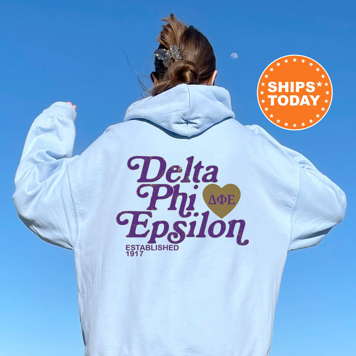 a woman wearing a white hoodie with delta phi epsion on it