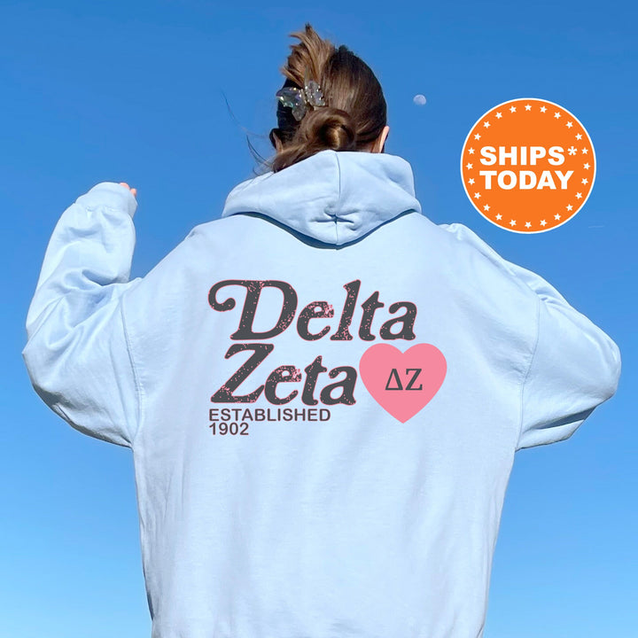 a woman with her back to the camera wearing a white delta zeta hoodie