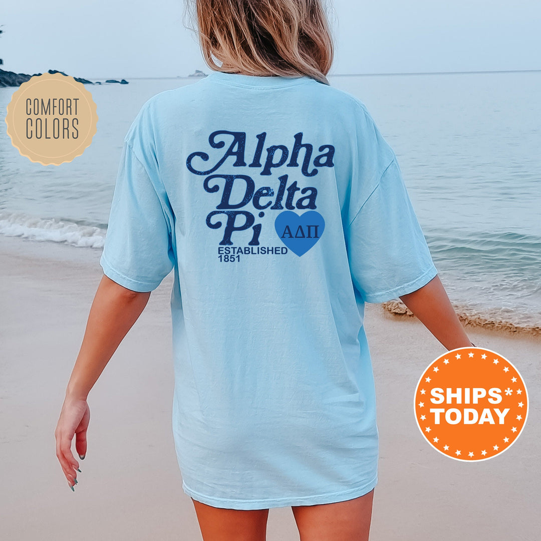a woman walking on the beach wearing a shirt that says aloha delta pi