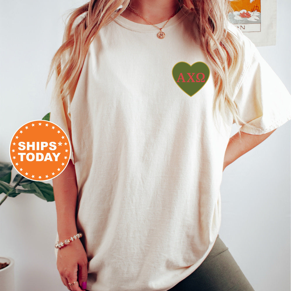 a woman wearing a white shirt with a green heart on it