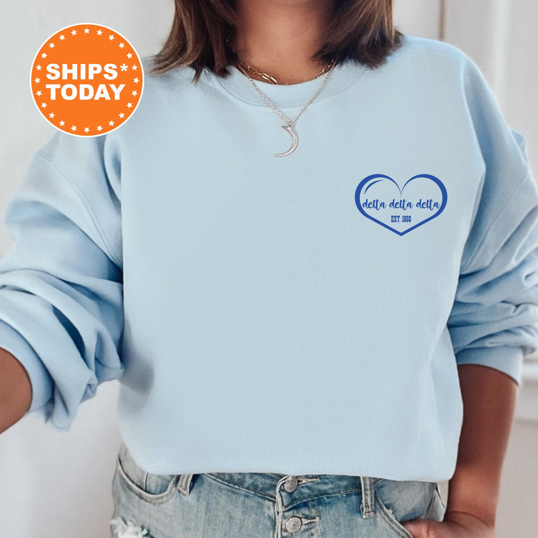 a woman wearing a blue sweatshirt with a heart on it