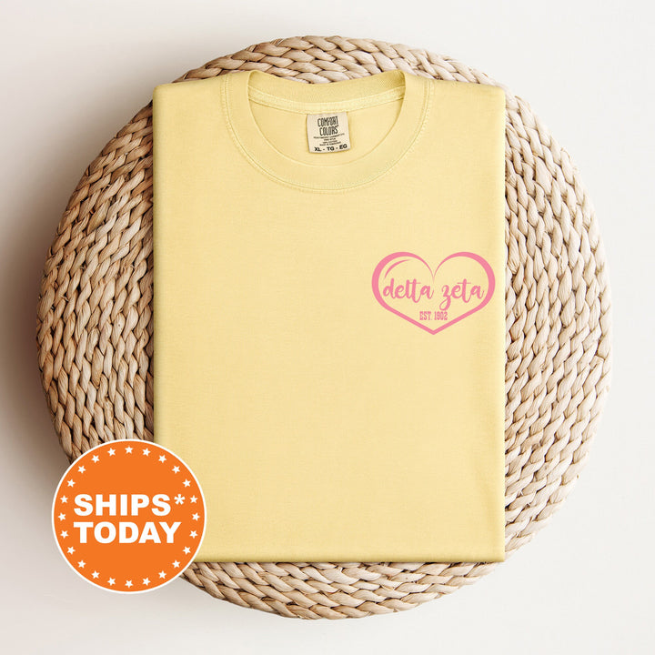 a yellow shirt with a pink heart on it