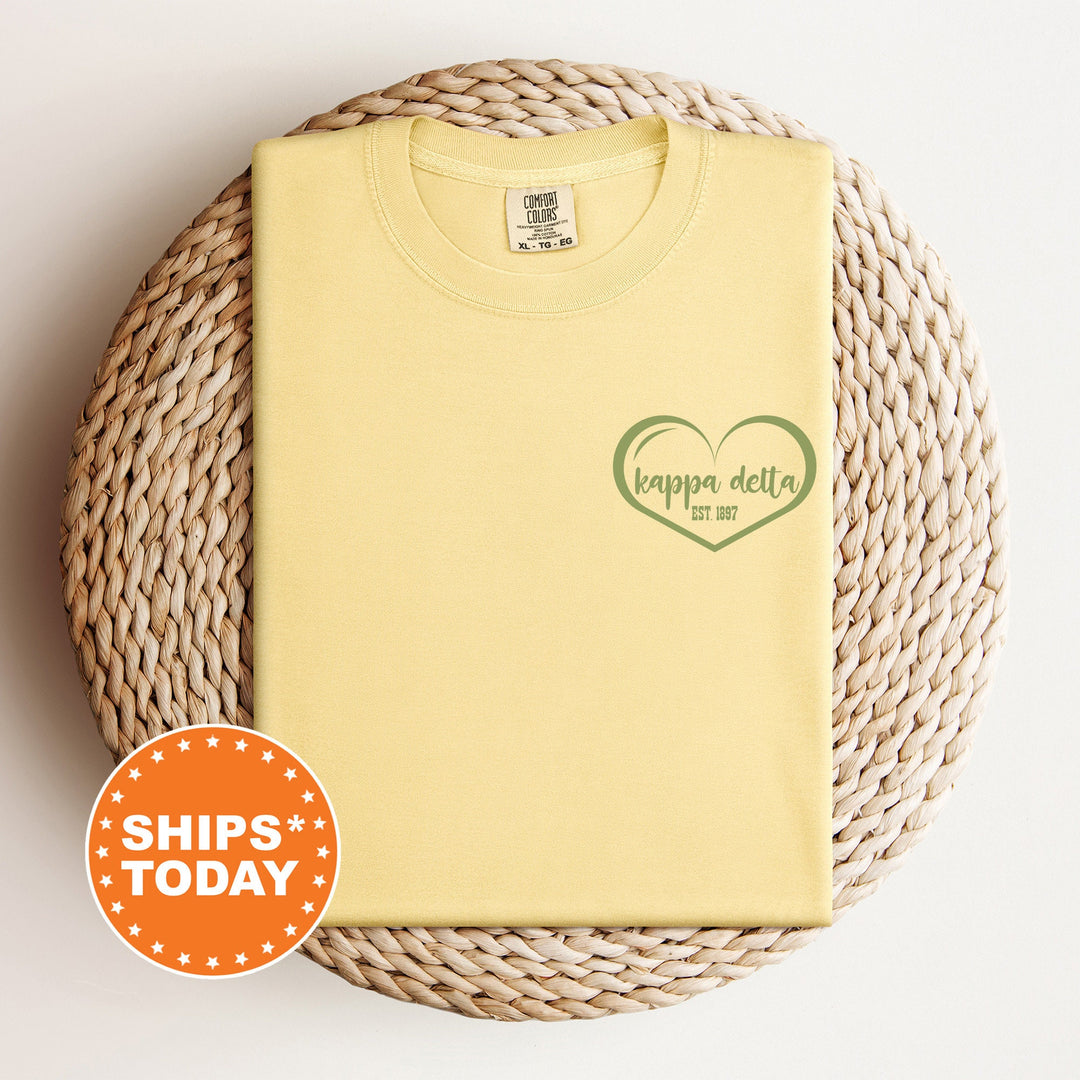 a yellow t - shirt with a green heart on it