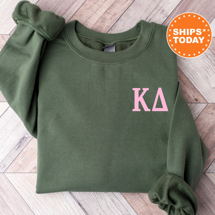 a green sweatshirt with pink letters on it