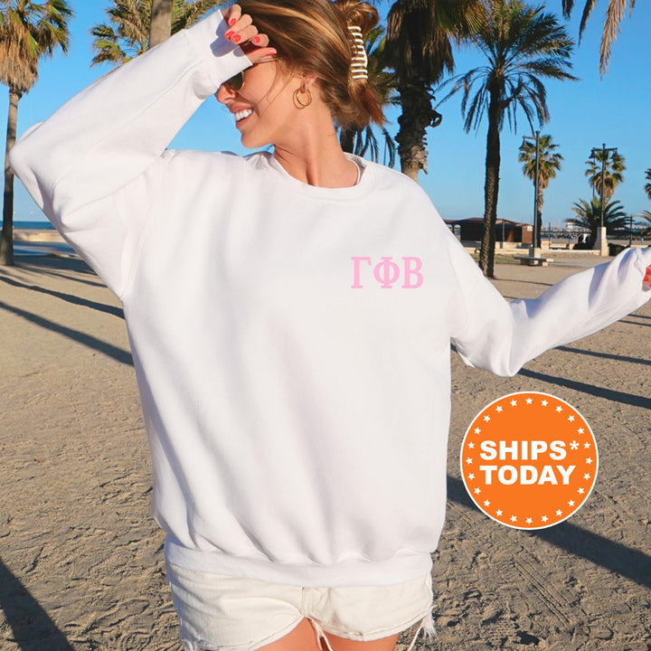 a woman wearing a white sweatshirt with pink lettering on it