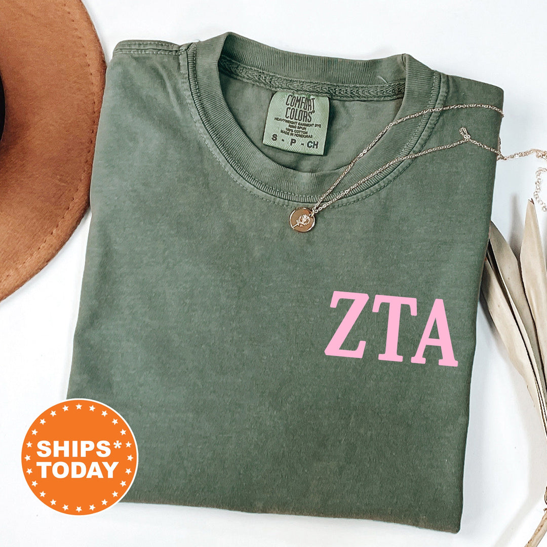 a green shirt with a pink zta on it