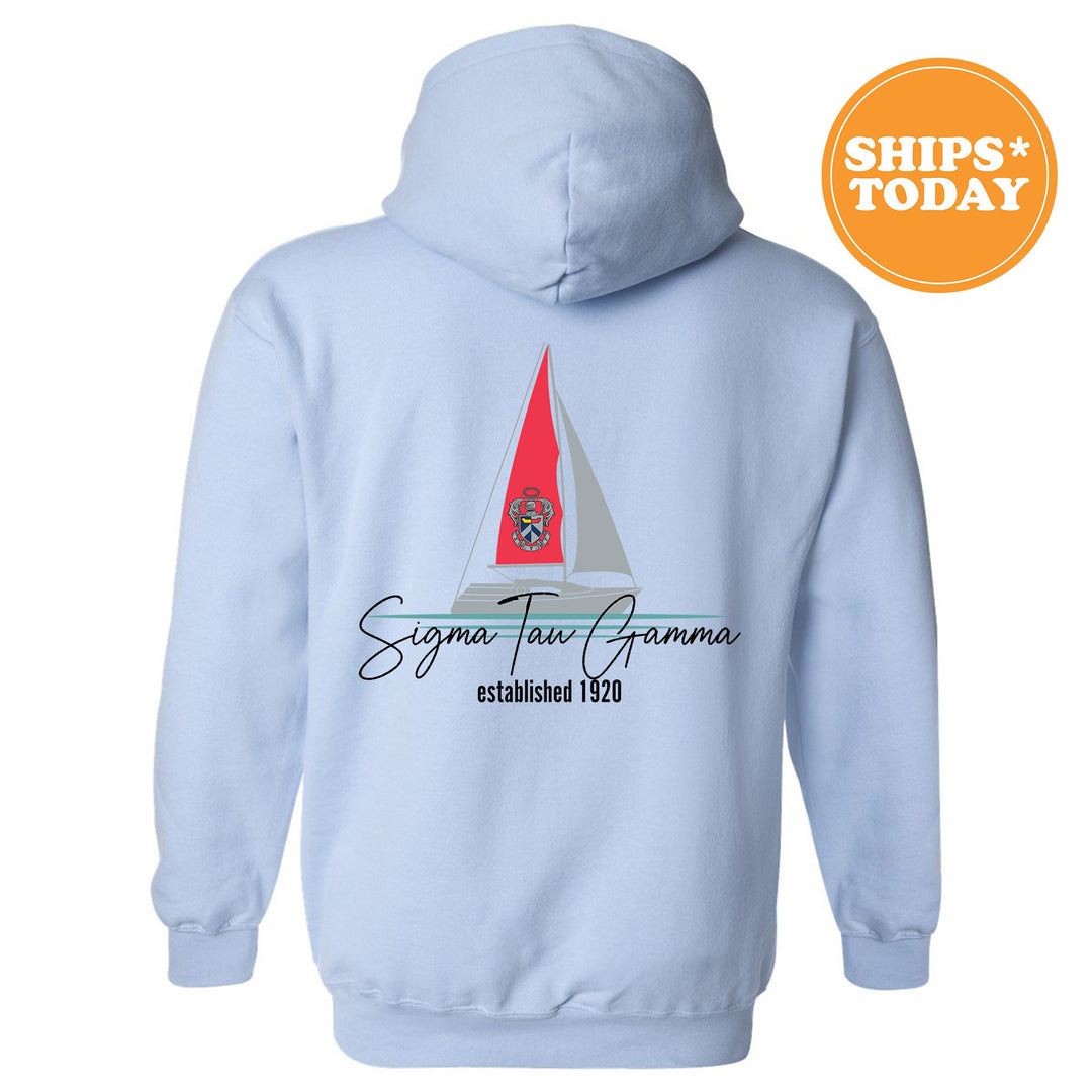 a light blue hoodie with a red sailboat on it