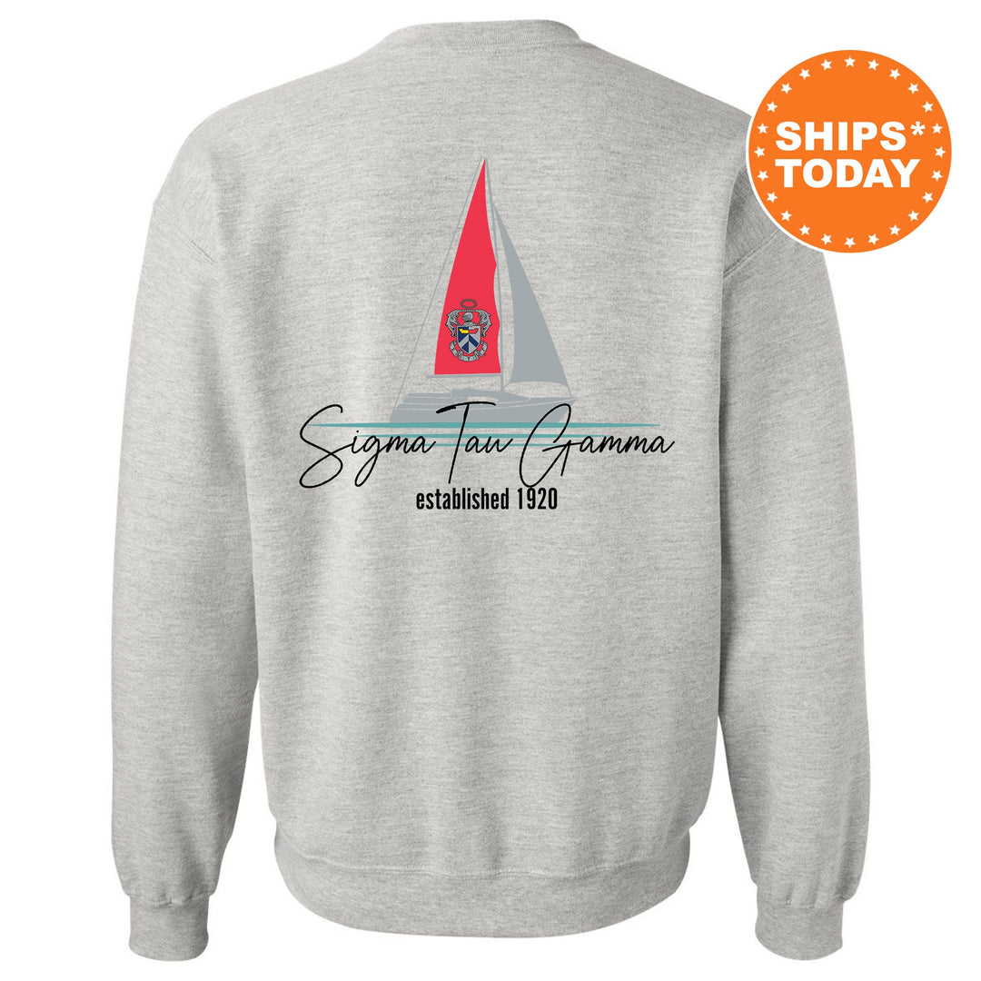 a grey sweatshirt with a red sailboat on it