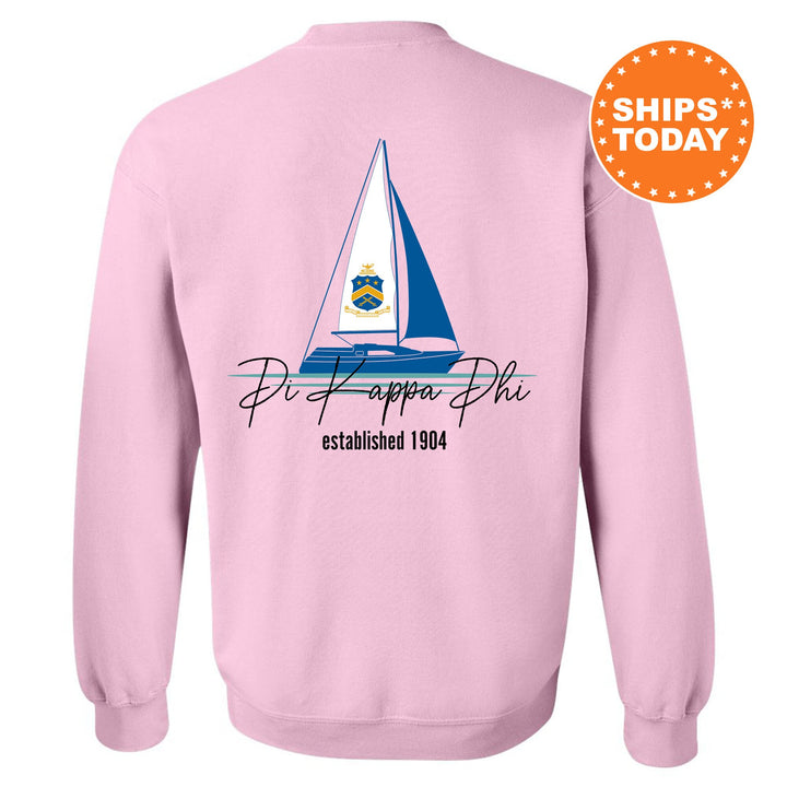 a pink sweatshirt with a sailboat on it