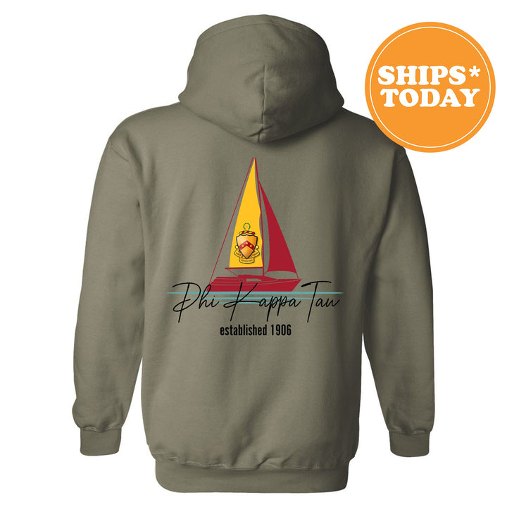 a gray hoodie with a yellow and red sailboat on it