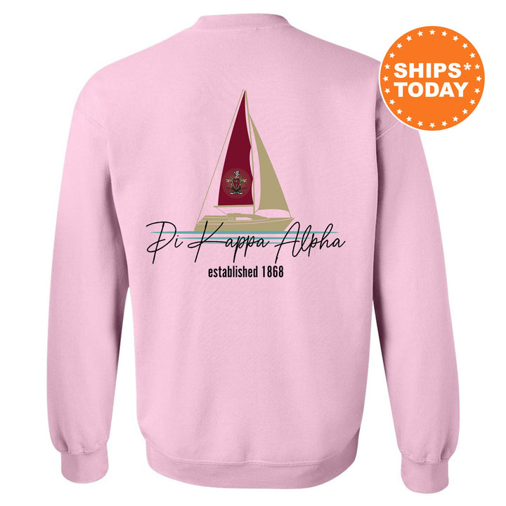 a pink sweatshirt with a sailboat on it