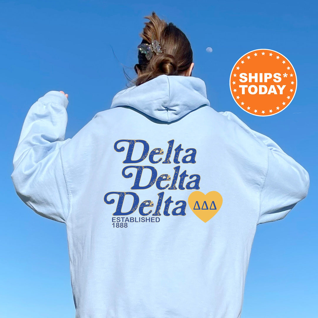 a woman with her back to the camera wearing a white delta delta hoodie