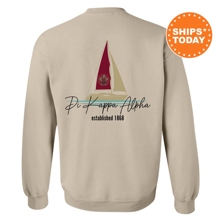 a white sweatshirt with a sailboat on it