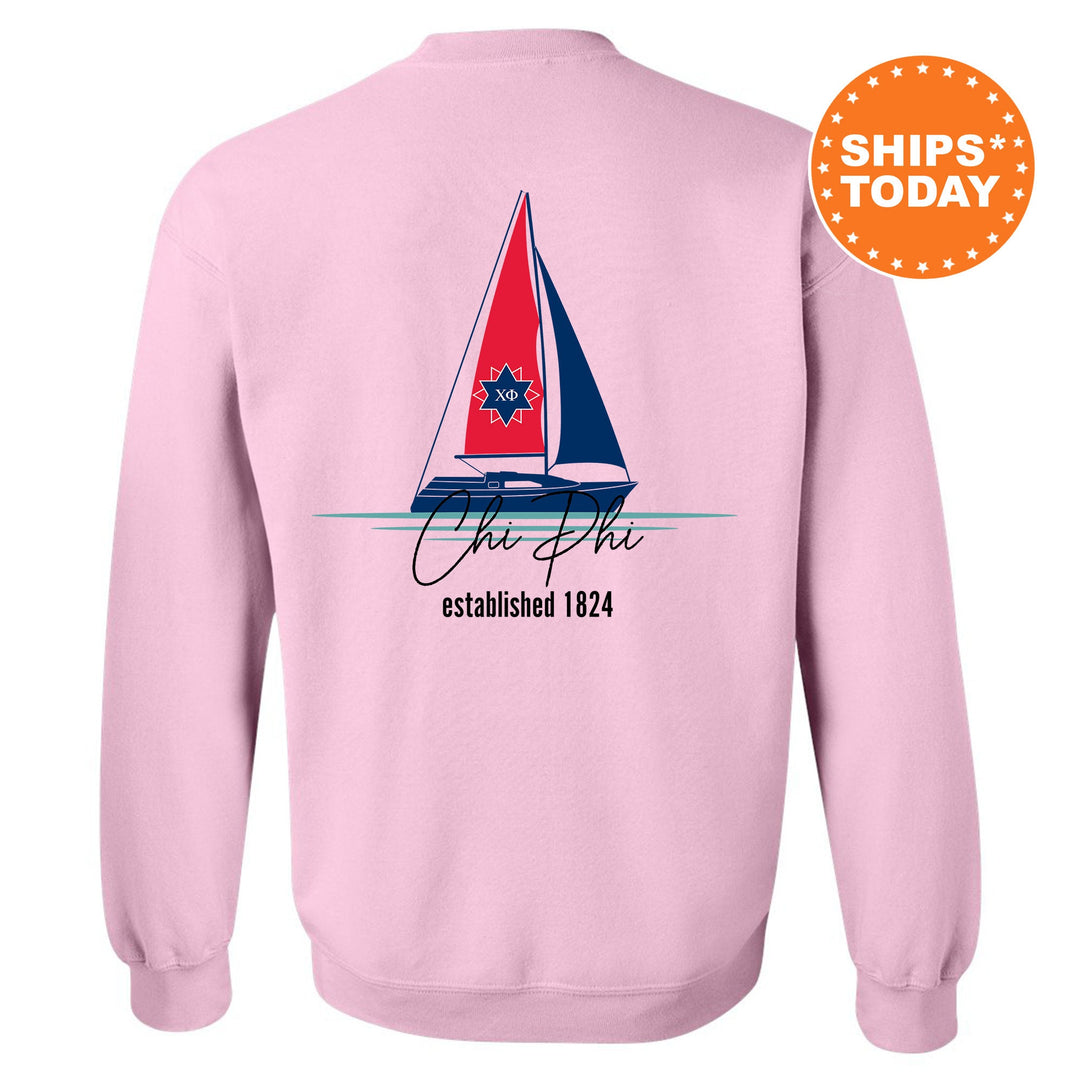 a pink sweatshirt with a sail boat on it