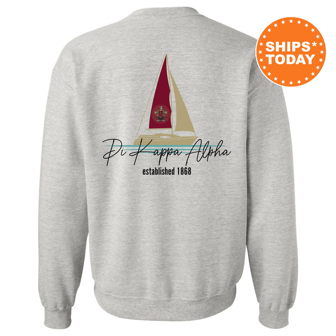 a white sweatshirt with a red sailboat on it