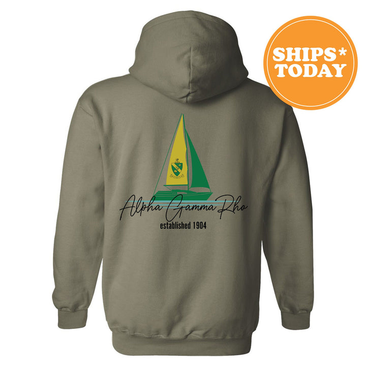 a gray hoodie with a green and yellow sailboat on it